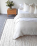 Serena Ivory Cream Textured Tassel Rug